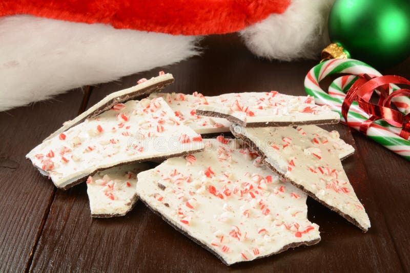 Delicous peppermint bark and candy canes on a Christmas table. Delicous peppermint bark and candy canes on a Christmas table