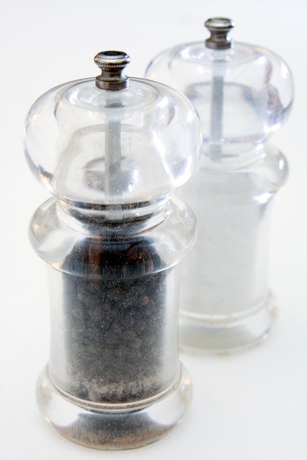 Pepper and salt grinders on white background