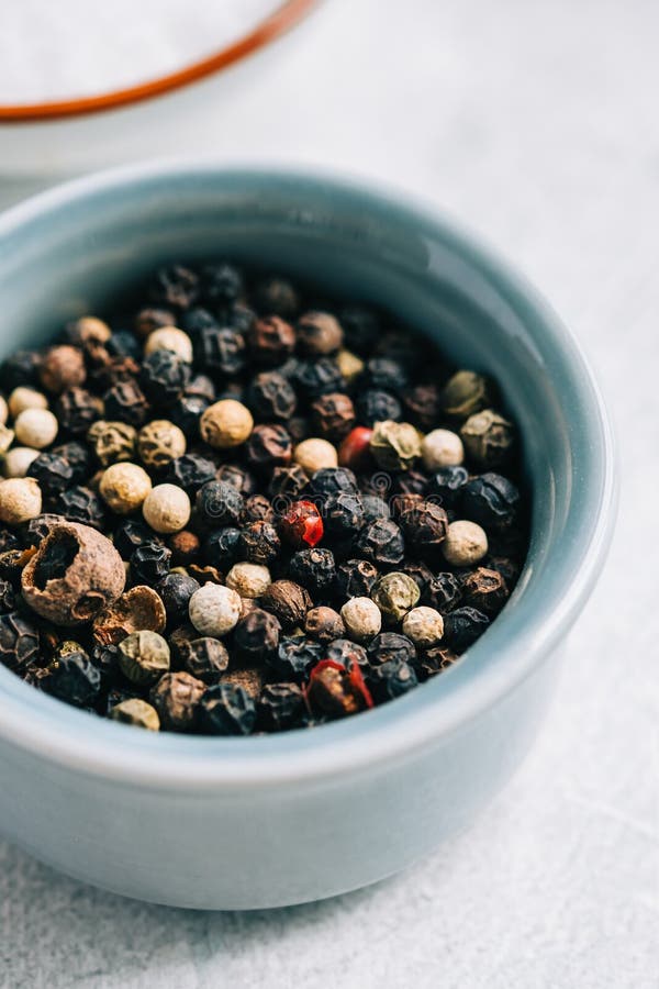 Peppercorns Mix in Small Bowl with Salt on the Table, Closeup Stock
