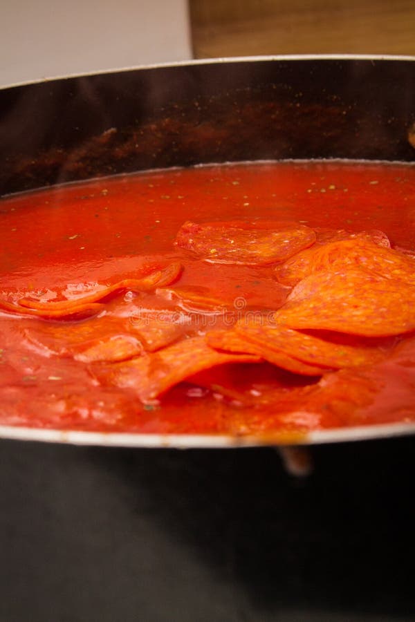 Pepperoni in Pasta Sauce stock image. Image of person 131450257