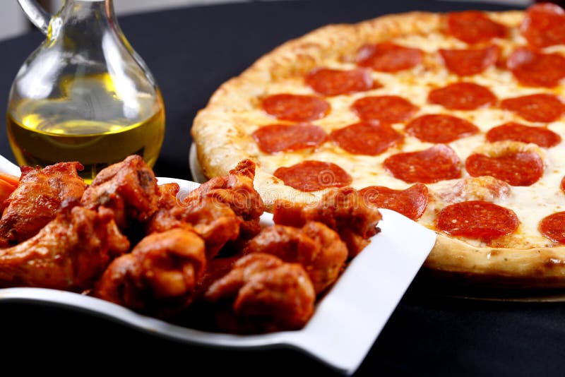 Pepperoni pizza with chicken wings