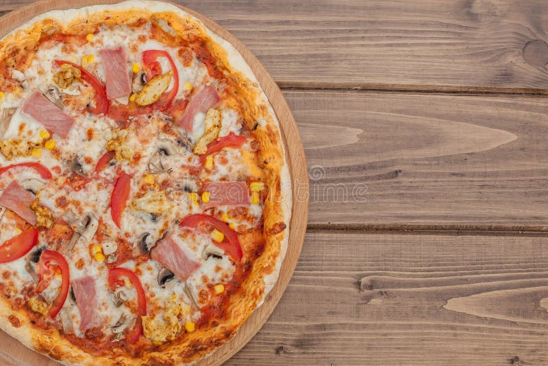Pepperoni Pizza with Mozzarella cheese, Ham, Tomatoes, pepper, Spices . Italian pizza royalty free stock image Pepperoni Pizza with Mozzarella cheese, Ham, Tomatoes, pepper, Spices . Italian pizza royalty free stock image