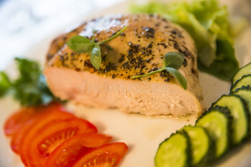 Peppery meat with juicy tomatoes and cucumbers on the plate