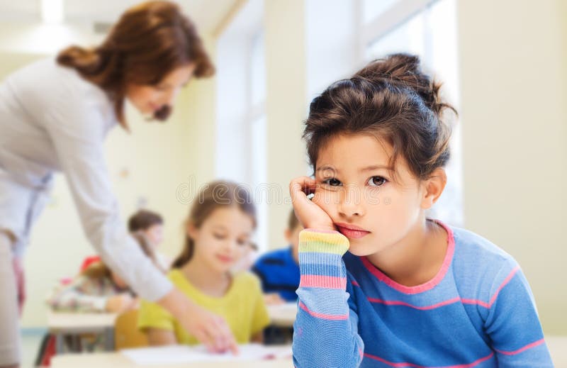 Pequeña colegiala triste o aburrida imagen de archivo