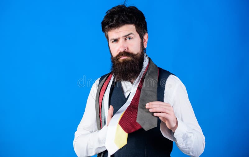 It is a perfect choice neckwear. Salesman offering a good choice of design neckties. Bearded man choosing tie from luxury collection, choice concept. Brutal hipster making a choice.