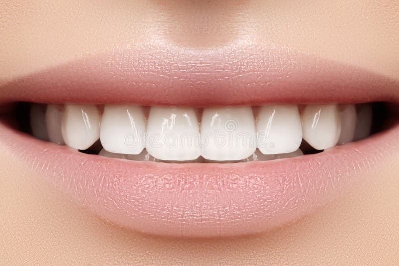 Perfect smile of young beautiful woman with perfect healthy white teeth. Dental whitening, ortodont, care tooth and wellness. Natural lipstick makeup on female lips. Perfect smile of young beautiful woman with perfect healthy white teeth. Dental whitening, ortodont, care tooth and wellness. Natural lipstick makeup on female lips