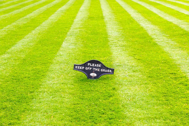 Perfectly Striped Freshly Mowed Garden Lawn with a Warning Sign Stock ...