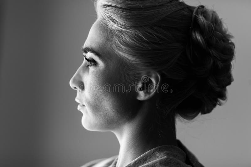 Perfil facial de la mujer rubia magnífica que mira hacia fuera la ventana fotografía de archivo libre de regalías Perfil facial de la mujer rubia magnífica que mira hacia fuera la ventana fotografía de archivo libre de regalías