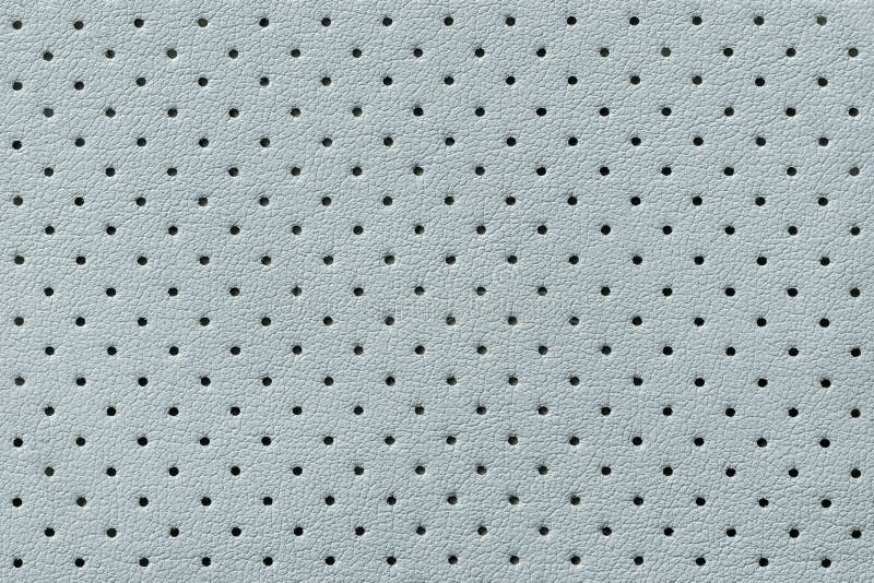 Perforated light blue leather texture background, closeup. backdrop from wrinkle skin