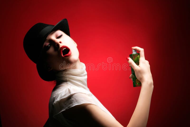 A beauty retro girl with perfume on red