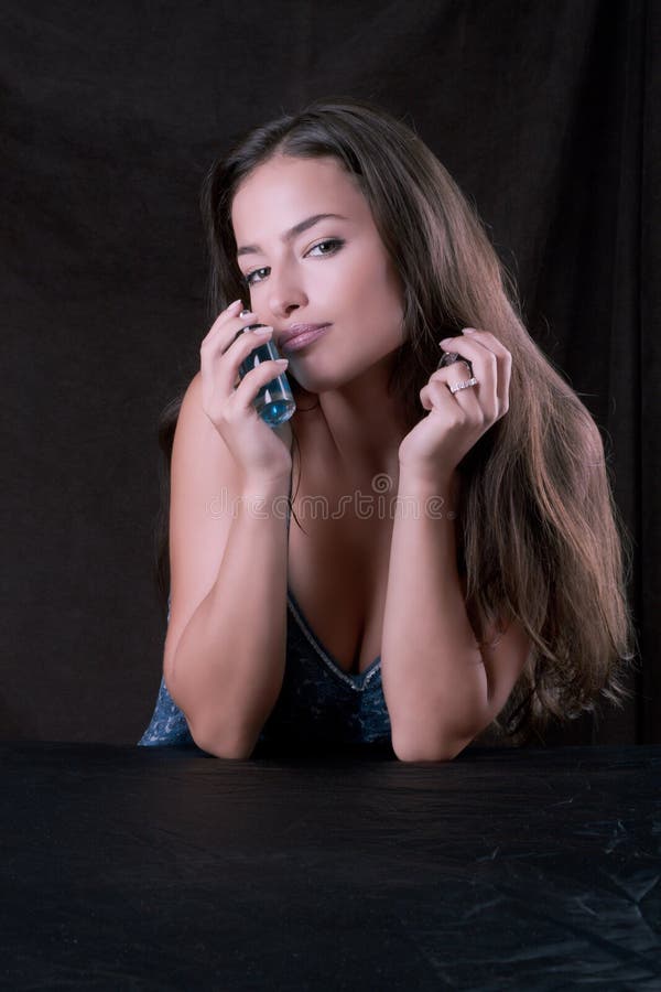 Beautiful woman with bottle of perfume