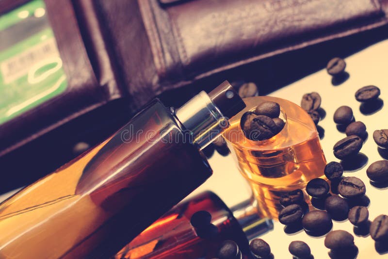 Perfume Bottle and Coffee Beans on the Wooden Background Stock Image