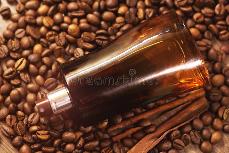 Perfume Bottle and Coffee Beans on the Wooden Background Stock Image