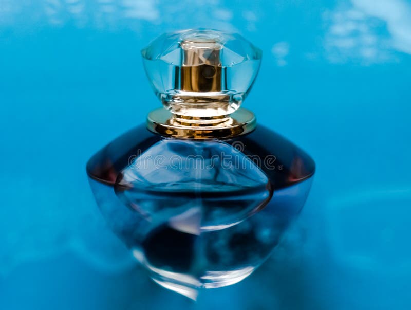 Perfume bottle under blue water, fresh sea coastal scent as glamour fragrance and eau de parfum product as holiday gift, luxury. Perfumery, cosmetics and stock photography Perfume bottle under blue water, fresh sea coastal scent as glamour fragrance and eau de parfum product as holiday gift, luxury. Perfumery, cosmetics and stock photography