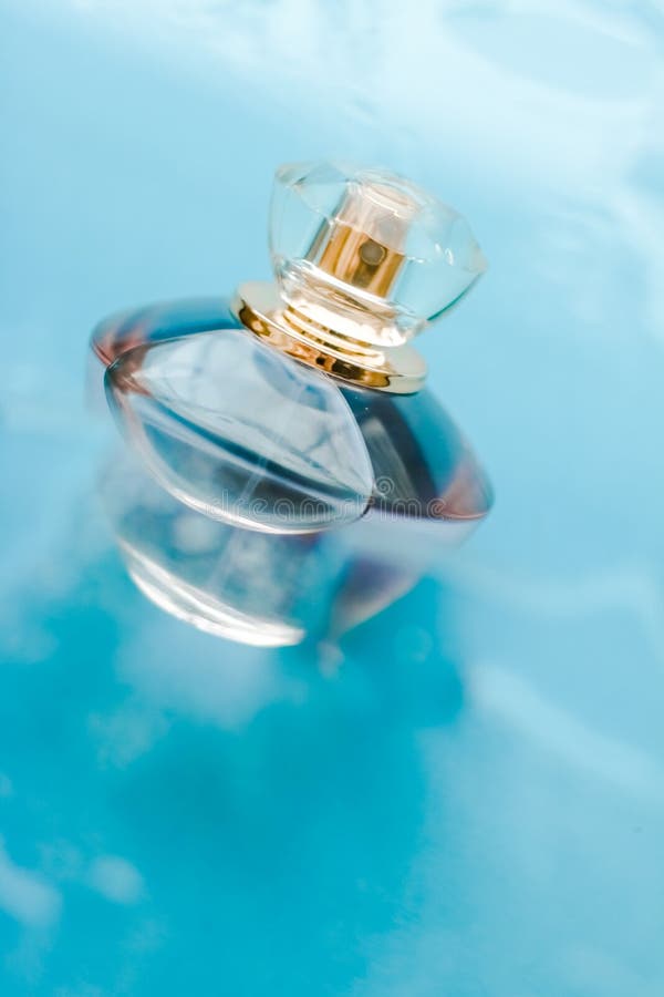 Perfume bottle under blue water, fresh sea coastal scent as glamour fragrance and eau de parfum product as holiday gift, luxury. Perfumery, cosmetics and royalty free stock photo Perfume bottle under blue water, fresh sea coastal scent as glamour fragrance and eau de parfum product as holiday gift, luxury. Perfumery, cosmetics and royalty free stock photo
