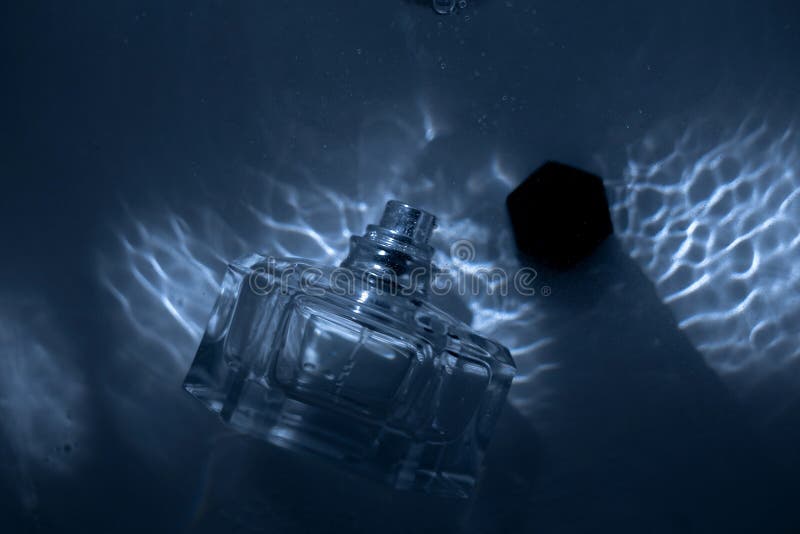 Perfume bottle under water stock image. Image of container 234945009