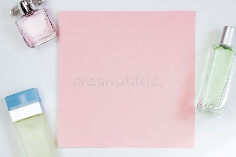 Perfume bottles on a pink background. Pink empty card, sheet for writing. Layout for adding tags. Top view, flat lay, copy space stock photography Perfume bottles on a pink background. Pink empty card, sheet for writing. Layout for adding tags. Top view, flat lay, copy space stock photography