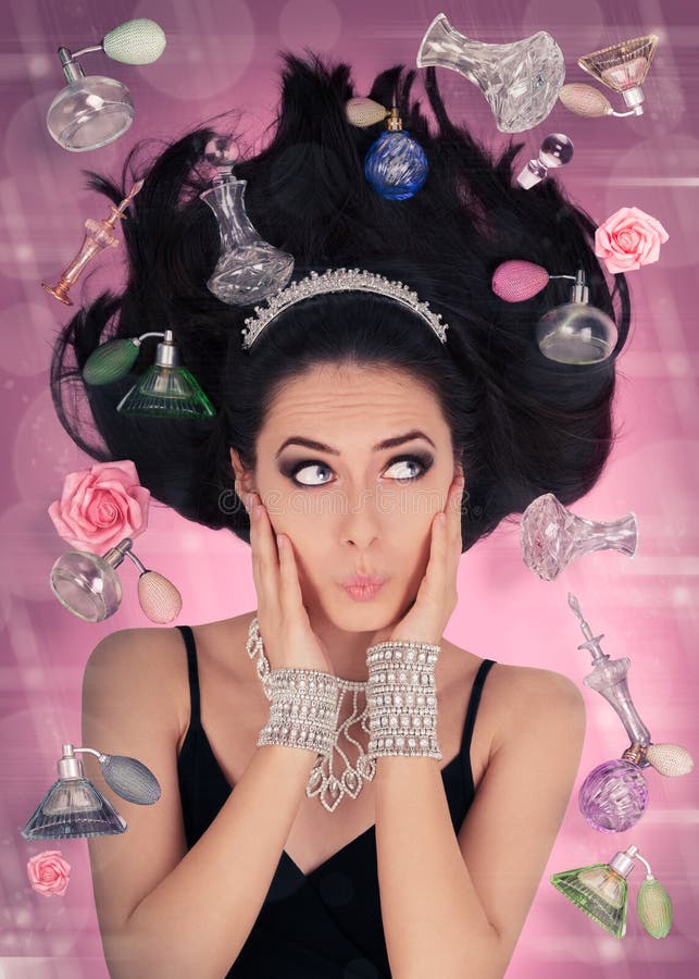 Beautiful young woman surrounded by floating perfume bottles in a glamour portrait. Beautiful young woman surrounded by floating perfume bottles in a glamour portrait