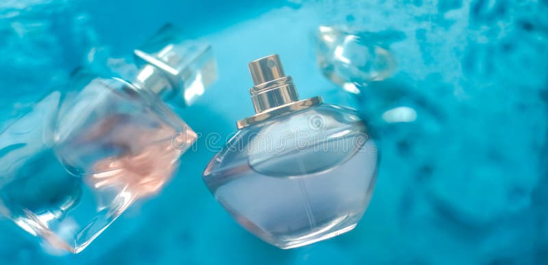 Perfume bottle under blue water, fresh sea coastal scent as glamour fragrance and eau de parfum product as holiday gift, luxury. Perfumery, cosmetics and royalty free stock images Perfume bottle under blue water, fresh sea coastal scent as glamour fragrance and eau de parfum product as holiday gift, luxury. Perfumery, cosmetics and royalty free stock images