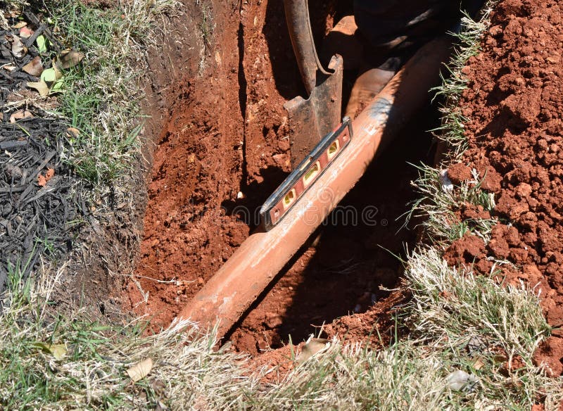 A horizontal boring device, sometimes referred to as a missile or submarine, is leveled as it is fed into red earth. A CATV trunk cable is being replaced. This no-trench method of cable replacement causes less turf damage. A horizontal boring device, sometimes referred to as a missile or submarine, is leveled as it is fed into red earth. A CATV trunk cable is being replaced. This no-trench method of cable replacement causes less turf damage.