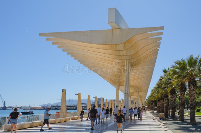 Malaga, Spain - May 26, 2022: People walking under the Pergolas de la Victoria in Malaga, Spain, to protect themselves from the strong sunrays of a sunny spring day. Malaga, Spain - May 26, 2022: People walking under the Pergolas de la Victoria in Malaga, Spain, to protect themselves from the strong sunrays of a sunny spring day