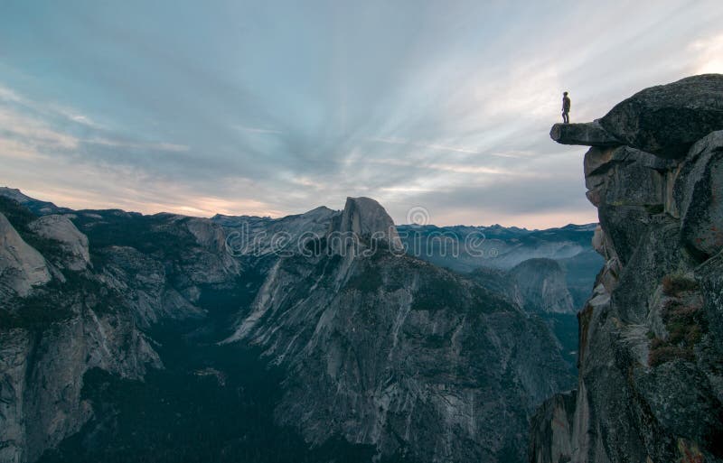 Perhaps the best view of glacier point where this unknown adventurer dares to stand on the edge stock photography Perhaps the best view of glacier point where this unknown adventurer dares to stand on the edge stock photography