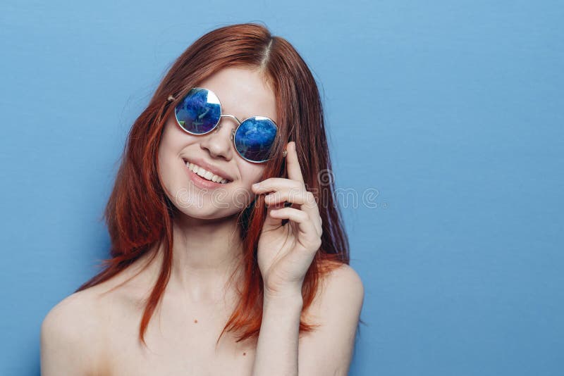 Perky Red Haired Woman In Blue Glasses Bare Shoulders Posing Stock