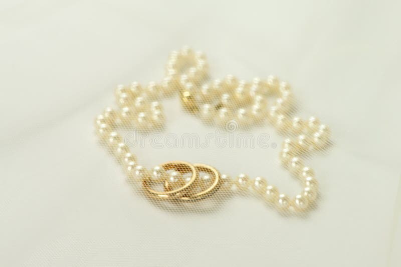 Perlenhalskette mit zwei goldenen Ringen stockfoto Perlenhalskette mit zwei goldenen Ringen stockfoto