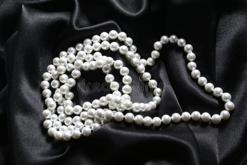 Pearls a necklace on a silk fabric. Pearls a necklace on a silk fabric