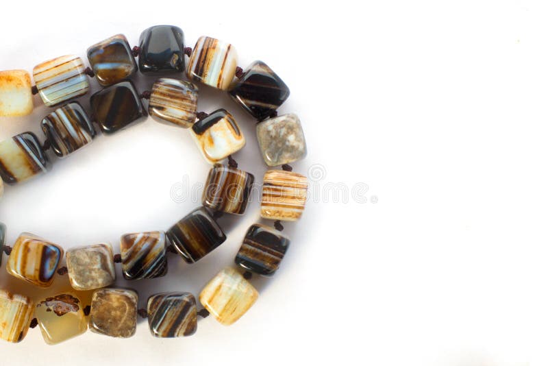 Brown colored agate beads isolated on white background. Brown colored agate beads isolated on white background