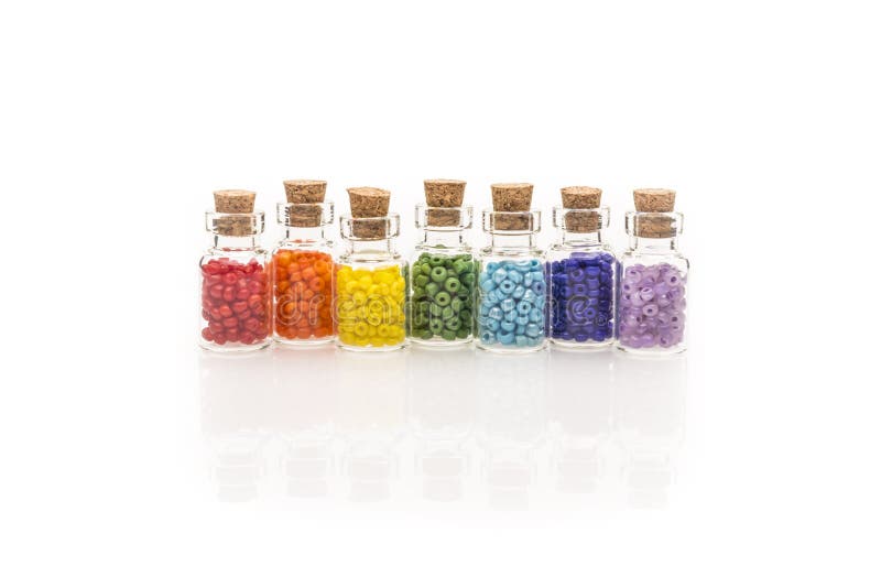 Perles d'arc-en-ciel dans des bouteilles en verre minuscules photographie stock Perles d'arc-en-ciel dans des bouteilles en verre minuscules photographie stock