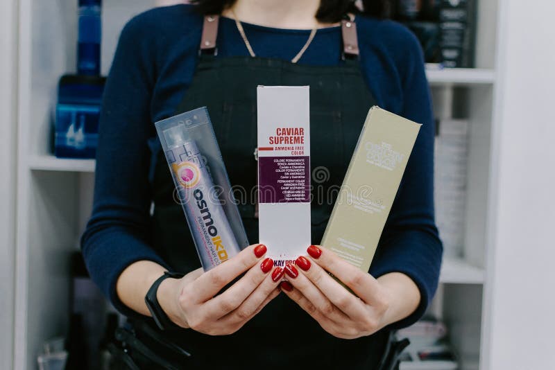 Permanent ammonia free hair colour, hair dye in hairdresser hand. Coloring in beauty salon. Color chart, palette, catalog in stock photos Permanent ammonia free hair colour, hair dye in hairdresser hand. Coloring in beauty salon. Color chart, palette, catalog in stock photos