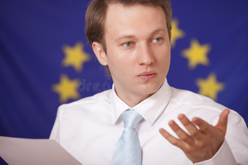 Press conference - man answering to questions in front of european union flag. Press conference - man answering to questions in front of european union flag