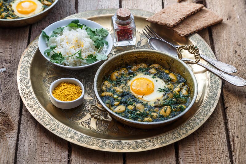 Persian Breakfast with Eggs, Bean and Dill in Copper Pan Stock Photo