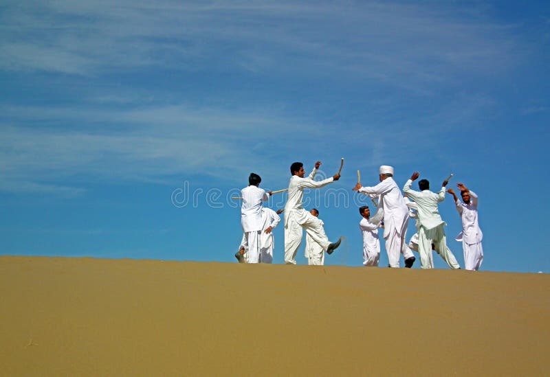 Persian folk dancers on sand dune in a festival in Eastern Iran