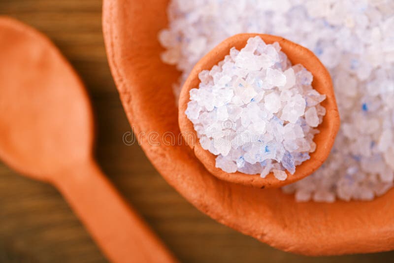 Persian Blue Iranian Crystal Rock salt in rustic clay bowls on wood. Persian Blue Iranian Crystal Rock salt in rustic clay bowls on wood