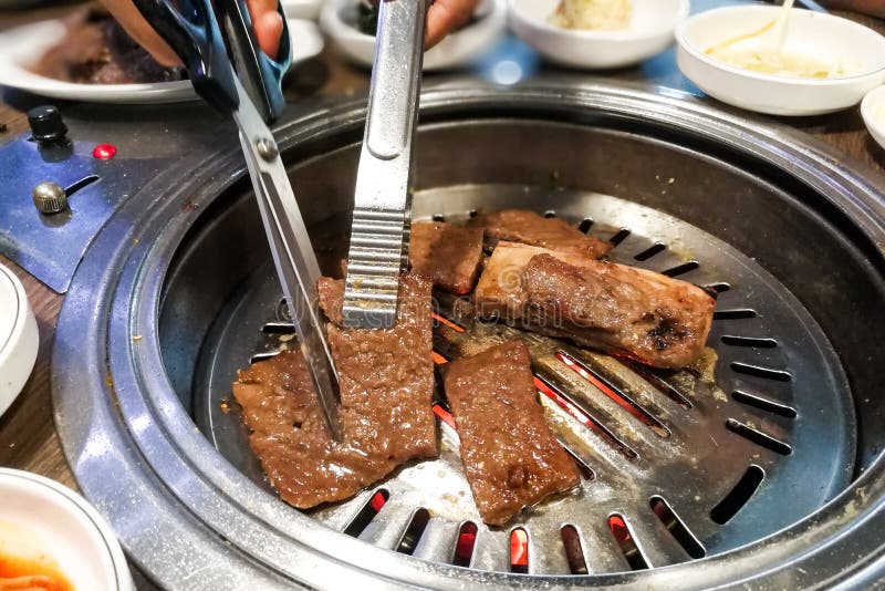 Person Barbecue Beef on Bbq Pit during Korean Meal Set Stock Image