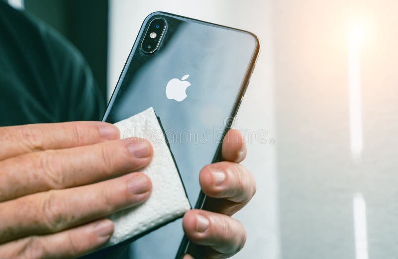 Person Cleaning mobile phone screen with disinfecting wipes for clean smartphone. COVID-19 Coronavirus outbreak contamination royalty free stock images Person Cleaning mobile phone screen with disinfecting wipes for clean smartphone. COVID-19 Coronavirus outbreak contamination royalty free stock images