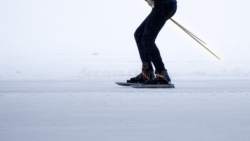 A person cross-country ice skating on a frozen lake