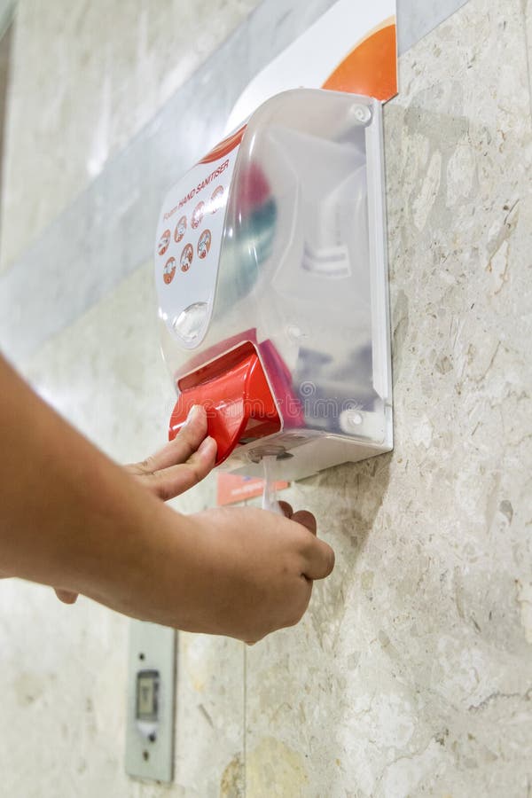 Person dispensing disinfectant sanitizer liquid onto hand at pub royalty free stock images Person dispensing disinfectant sanitizer liquid onto hand at pub royalty free stock images
