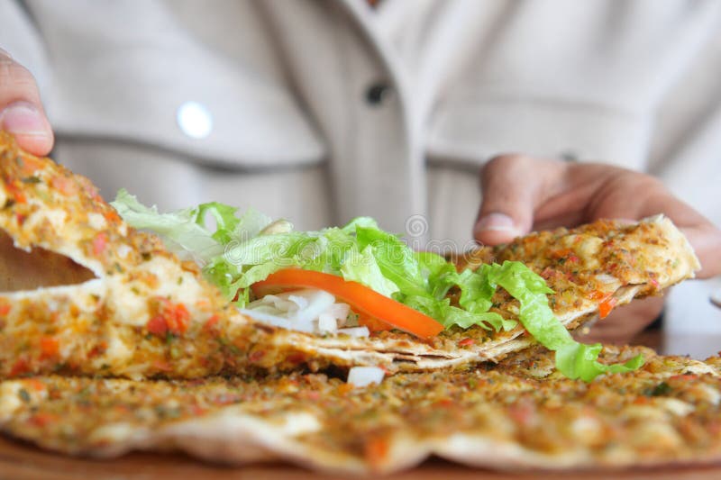 Person enjoying Freshly prepared turkish lahmacun stock photos