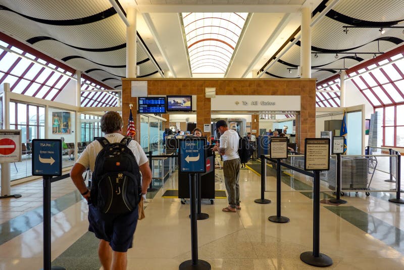 Person going through TSA Precheck line and regular line through airport security