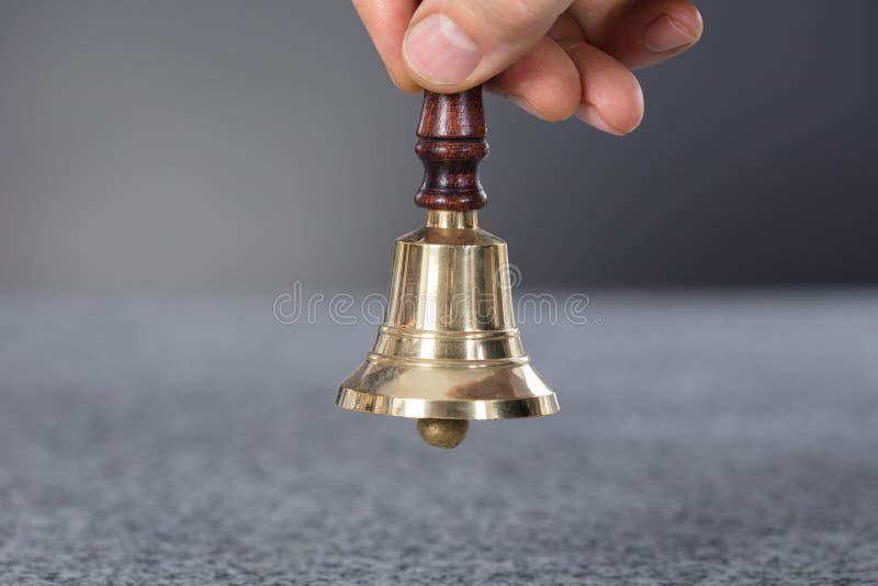 Person Hand Holding A Ring Bell royalty free stock photo