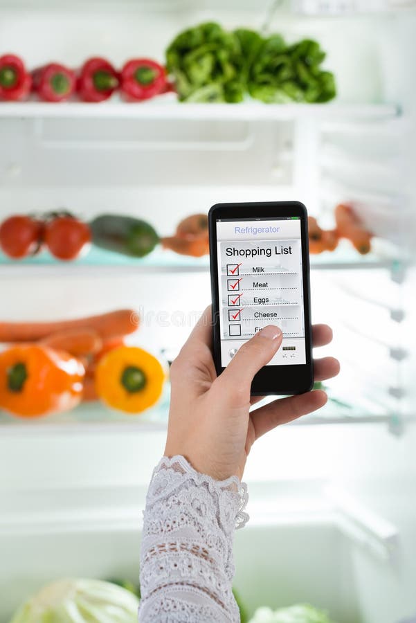 Person Hand With Mobile Phone Showing Shopping List stock photo Person Hand With Mobile Phone Showing Shopping List stock photo