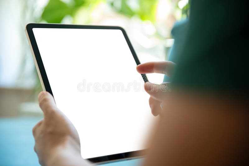 Person holding a tablet with a blank screen, in a bright, green environment. Perfect image for presenting tablet apps, user stock photos