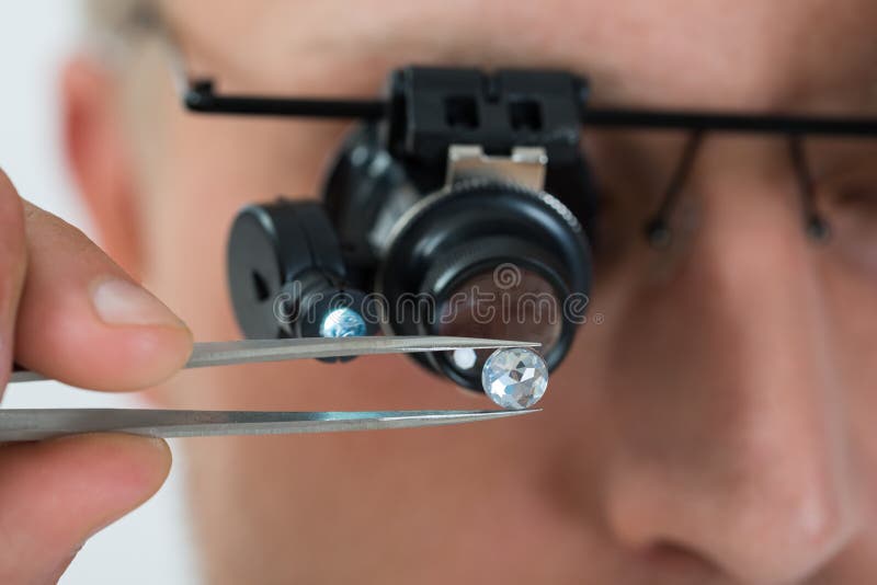 Person Looking At Diamond With Magnifying Loupe