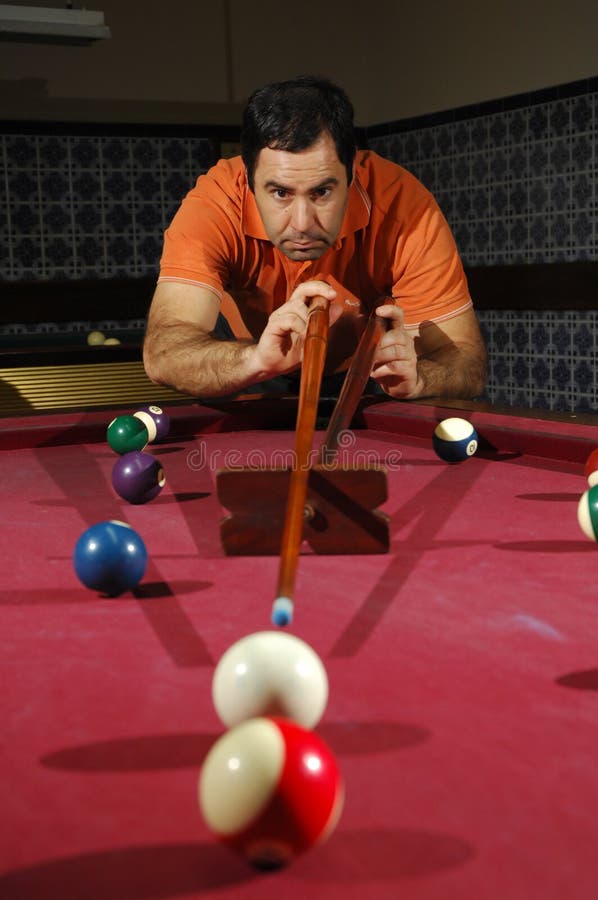 Person playing snooker (focus on the player)