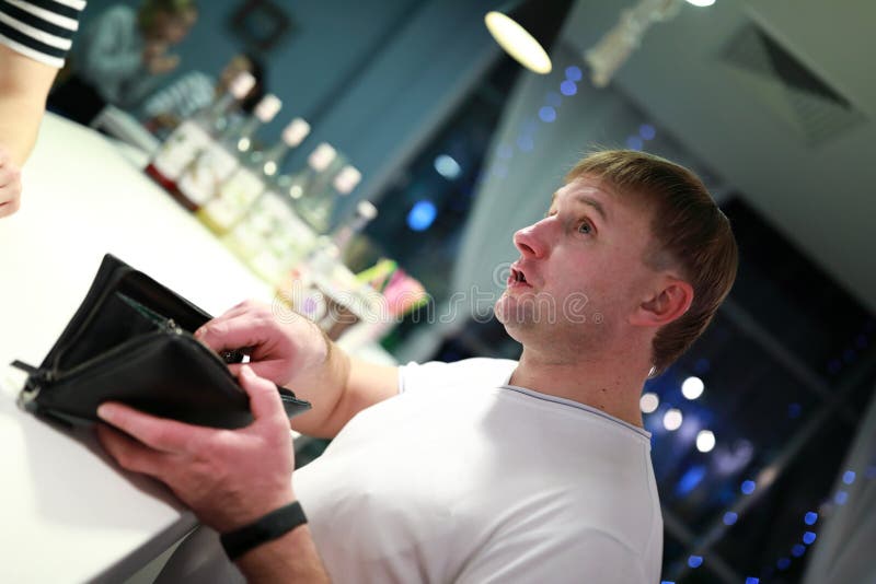 Person with purse at bar