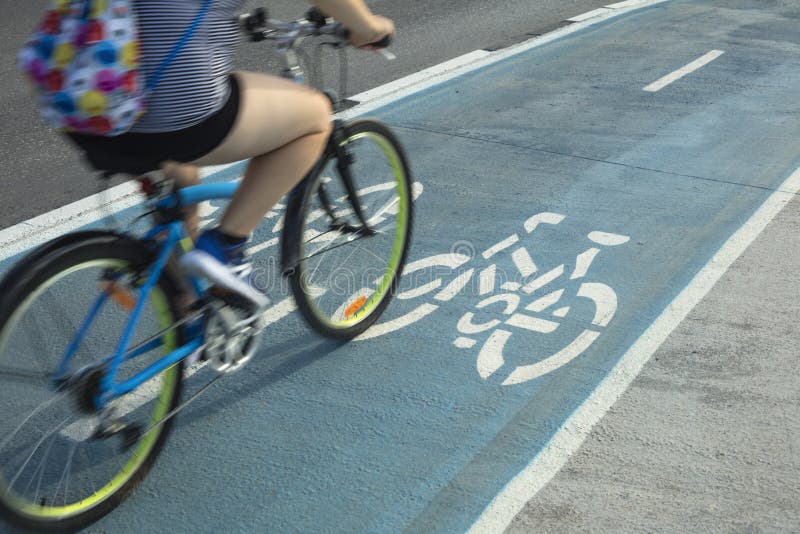 Person riding a bike on bicycle lane or cycle path outdoors