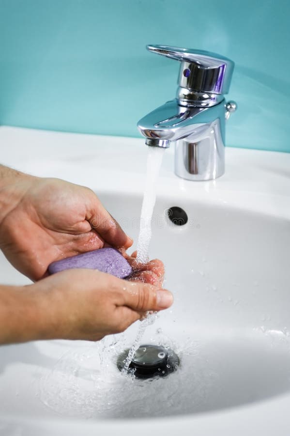 Person s hands washing under tap